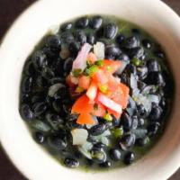 Black Beans · Slow-cooked black beans with Spanish onions, our Mexican seasoning, and cilantro, topped wit...