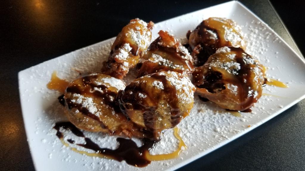 Deep Fried Oreos · Six hand-battered oreos deep fried to perfection and topped with a drizzle of chocolate sauce and dusted with powdered sugar.