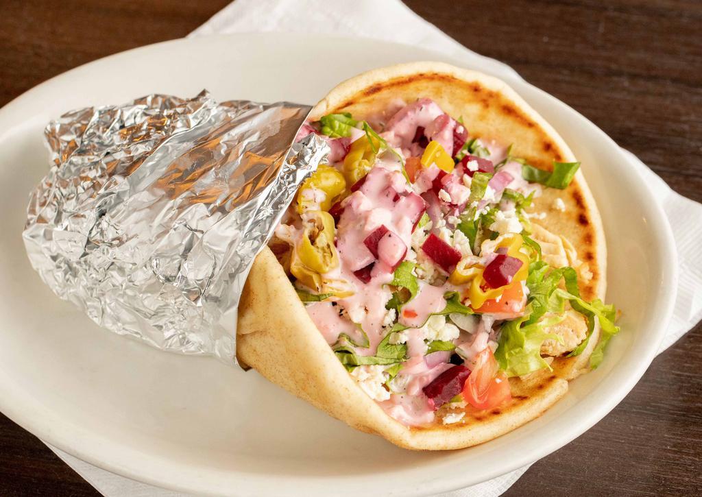 Chicken Greek Pita · Marinated chicken breast, with lettuce, tomatoes, onion, pepperoncini & beets topped off with feta & creamy greek dressing.