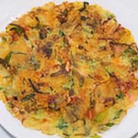 Seafood Pancake (Haemul Pajeon) · Korean pancake: pan fried with seafood, green onions, vegetables; served with seasoned sauce.