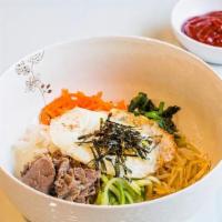 Bibimbap · Rice topped with beef, egg, rope flower, carrots, radish, bean sprouts, zucchini, and red pe...