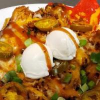 Triple Barbecue Nachos · Barbecue beans, sweet sauce, and your choice of pulled pork or chicken over tortilla chips, ...
