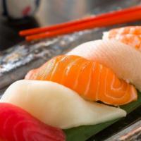 Sushi Dinner · Seven pieces of nigiri and choice of one reg roll served with soup and salad.