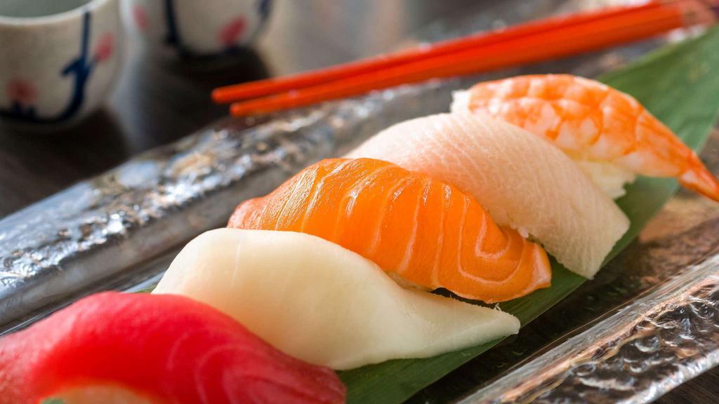 Sushi Dinner · Seven pieces of nigiri and choice of one reg roll served with soup and salad.