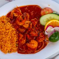 Camarones A La Plancha · Grilled jumbo shrimp served with rice and salad.