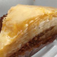 Baklava · Fine layers of phyllo pastry with walnuts topped with cinnamon, powdered sugar, and honey.
