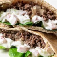 Gyro Pita · Seasoned lamb and beef, grilled crisp on a hand-stretched flatbread.