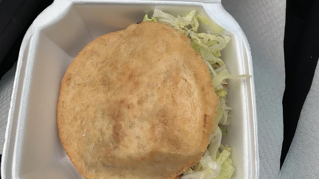 Gordita · Corn cake filled with ground beef, tomatoes, lettuce and cheese.
