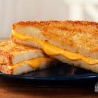 Parmesan Crusted Regular Grilled Cheese · Regular Grilled Cheese on Parmesan Crusted Sourdough. Includes Chips