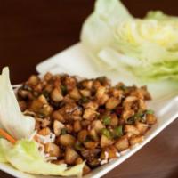 Lettuce Wraps · Wok-seared chicken, mushrooms, green and red pepper, and water chestnuts with crisp lettuce ...