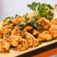 Basil Chicken · Juicy chicken fried with an original garlic pepper and mixed with Thai basil.