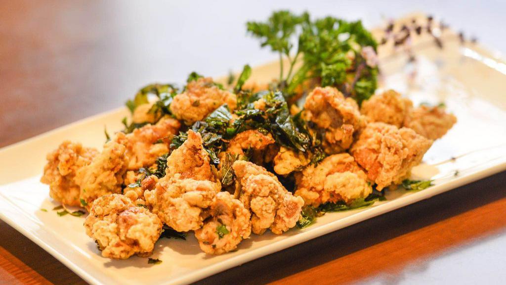 Basil Chicken · Juicy chicken fried with an original garlic pepper and mixed with Thai basil.