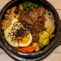 Bulgogi Hot Stone Pot Bibimbab (Beef) · Your traditional Korean Bibimbap dish served in a sizzling hot stone bowl with Bulgogi.