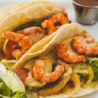 Tacos Gobernador · 3 flour tortillas filled with grilled shrimp, onions, bell peppers, and tomatoes, topped wit...