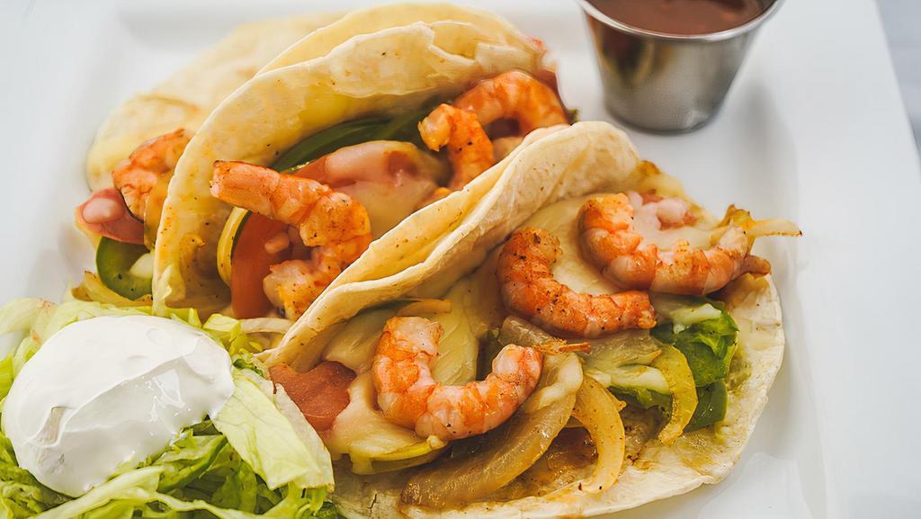 Tacos Gobernador · 3 flour tortillas filled with grilled shrimp, onions, bell peppers, and tomatoes, topped with melted cheese. served with rice.