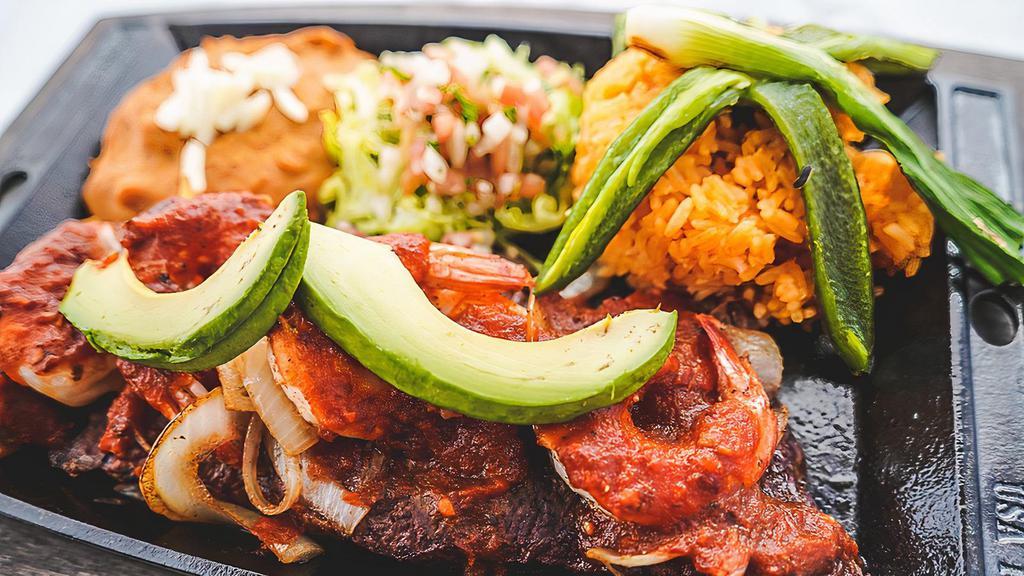 Carne Asada A La Diabla · Charbroiled sirloin steak topped with grilled onions, and shrimp covered in our chef's signature sauce. served with rice and beans. lettuce, tomatoes, slice avocado, cambray onions and a Chile toreado.