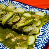 Aguachiles · Raw shrimp cured on fresh lime juice with cucumbers, onions, and avocado topped with a spicy...
