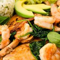 Pescado Al Horno · Two grilled fish fillets with spinach, mushrooms, and shrimp cooked in foil. Served with let...