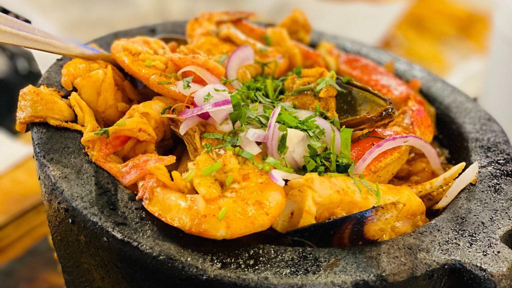 Molcajete Ale · Mussels, shell-on shrimp, peeled shrimp, crab meat, scallops, octopus, and crawfish topped with our chef’s Nayarit style sauce. Served with rice and tossed salad.