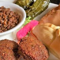 Vegetarian Tray · Two veggie grape leaves, one spinach pie, two falafel and mujadara. Served with soup or salad.