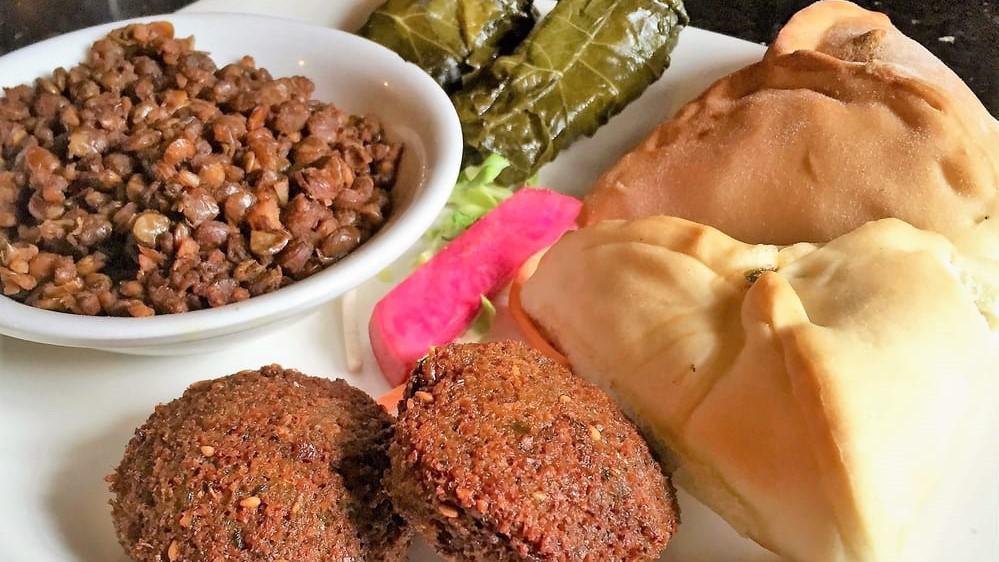 Vegetarian Tray · Two veggie grape leaves, one spinach pie, two falafel and mujadara. Served with soup or salad.