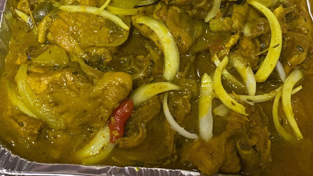 Jamaican Curry Chicken With White Rice · Various chicken pieces (leg thigh) seasoned with jamaican curry garlic onions scallions peppers and other seasonings.