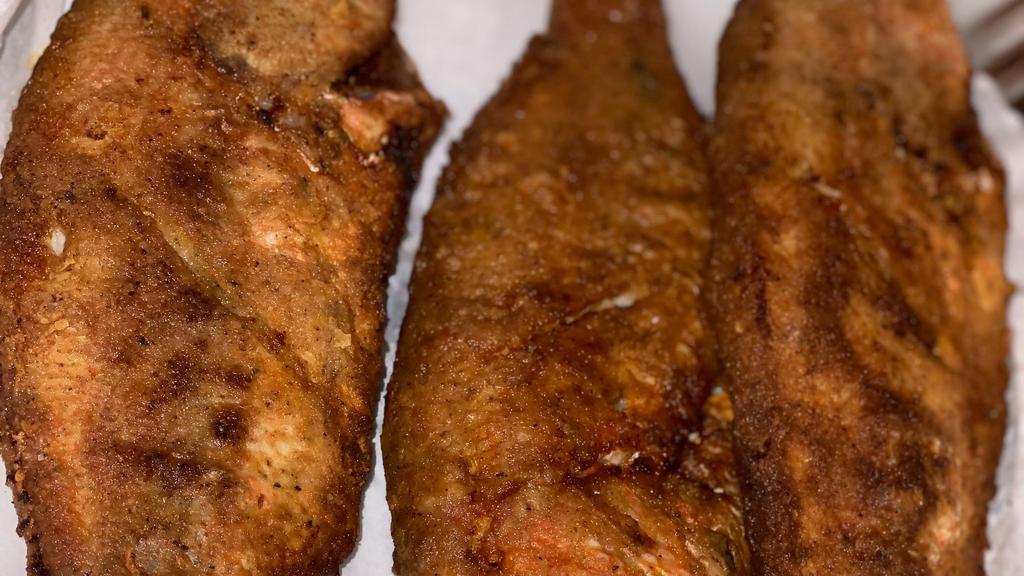 Haitian Fried Fish · Well seasoned whole snapper or butter fish lightly floured and fried to a golden brown perfection
