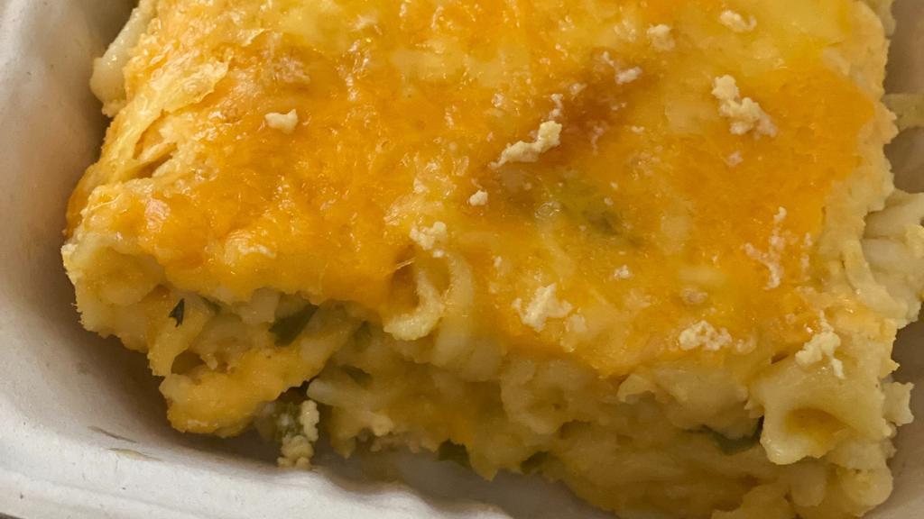 Haitian Baked Mac And Cheese · Cooked ziti pasta mixed with sautéed onions garlic scallions and bell peppers in butter melted cheeses evaporated milk caribbean seasonings topped with cheese and baked to a golden perfection.