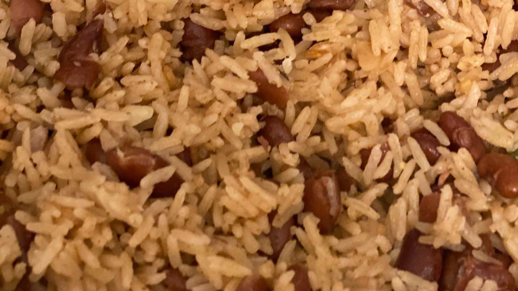 Rice And Beans · Jasmine rice cooked with sautéed red kidney beans in vegetable oil with haitian epis (seasoning) garlic scallion onions and cream of coconut milk.