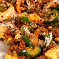 Lunch Nachos Supremos · Your choice of shredded chicken or ground beef covered with cheese dip, lettuce, sour cream,...