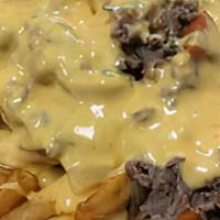Philly Cheesesteak Potatoes · Shaved Ribeye Steak Served with Homemade Queso, Peppers and Onions Served atop your choice o...