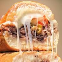 Italian Beef · Italian Beef with pepper cheese sauce topped with shredded mozzarella cheese. Served with fr...