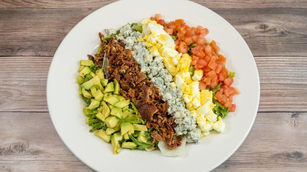 Cobb Salad · Gluten free. Fresh mixed greens with tomatoes, bacon, bleu cheese, hard boiled egg & avocado with choice of dressing.