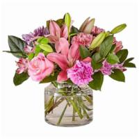 Butterfly Bouquet · Pink lilies, pink roses, pink carnations, and lavender mums and lemon leaf greenery.