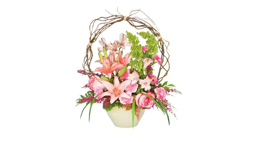 Trellis Flower Garden · This garden-style arrangement has full blooms of roses, lilies and bells of Ireland framed by an arched trellis. Appropriate when sent to the service or someone's home, it is a beautiful way to say 