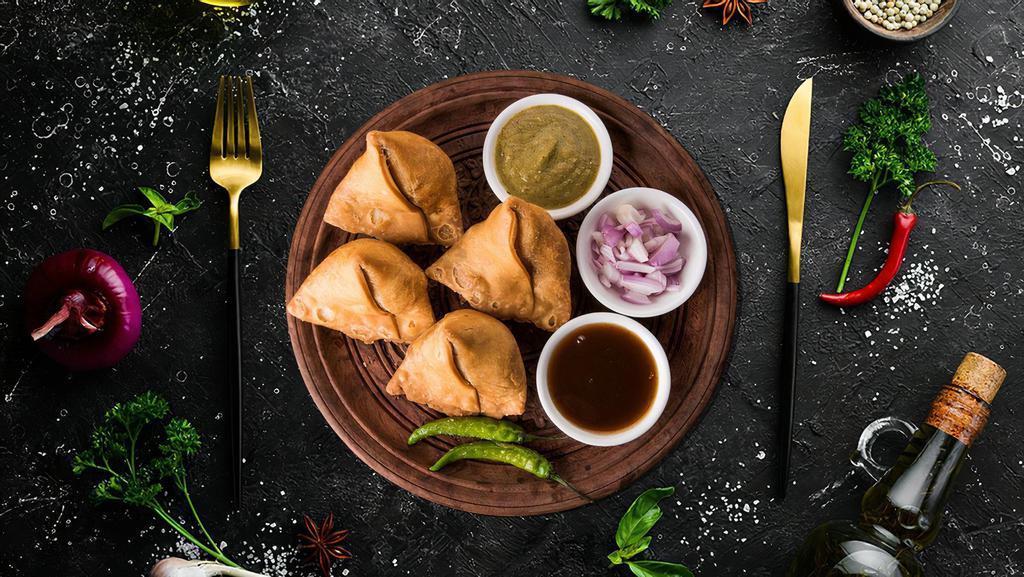 Vegetable Samosa (2 Pcs) · Flaky pastry dumplings filled with spiced potatoes, vegetables and deep fried till crisp and golden