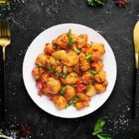 Cauli Manchurian Bites · Cauliflower cooked and sautÃ©ed with chopped onions, peppers, garlic, soy, and chili sauce.