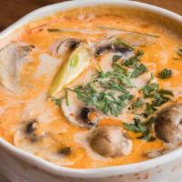 Large Tom Kha · Thai coconut milk soup with mushrooms, tomatoes, green onion, cilantro.