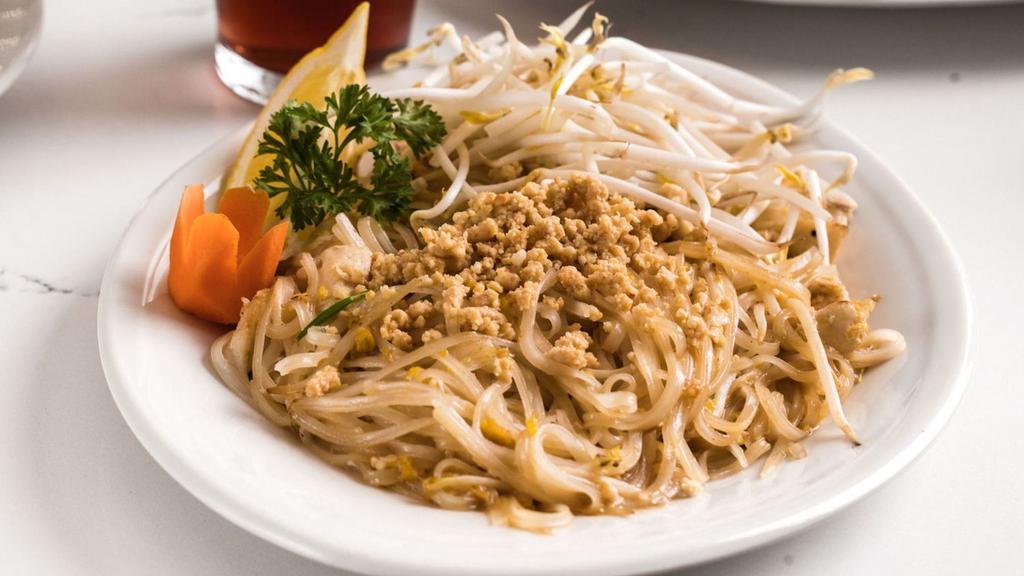Pad Thai (Gf) · Thin rice noodles stir fried with bean sprouts, green onion, and egg. Topped with crushed peanuts and lemon/lime wedge.