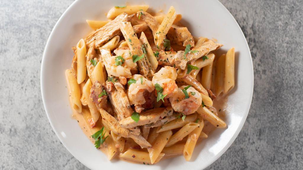 Shrimp Diavolo Pasta · A spicy combination of shrimp, chicken and chorizo in a heavy cream, crushed red pepper sauce. Served over penne noodles with garlic bread on the side.