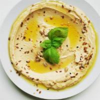 Hummus Dip · Garbanzo beans, tahini, garlic, lemon garnished with parsley and olive oil. Served with pita...