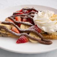 Strawberry And Banana Nutella Crepe · Strawberries, Banana, Nutella Drizzle, Whipped cream, and  Powdered Sugar.