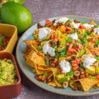 Super Nachos · Served with tomato, guacamole,jalapeños, beans, cheese, sour cream and your choice of meat o...