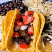 Steak Taco Dinner · Three tacos served with rice and beans. Choice of tortilla shell containing cilantro and oni...