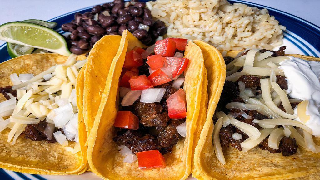 Steak Taco Dinner · Three tacos served with rice and beans. Choice of tortilla shell containing cilantro and onions.