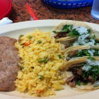 Lengua Taco Dinner · Three tacos served with rice and beans.