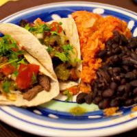 Two Taco Dinner · Two tacos with onions and cilantro served with rice and beans