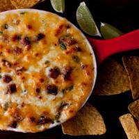 Queso Fundido With Chorizo · Melted cheese with chorizo. Tortillas on the side.