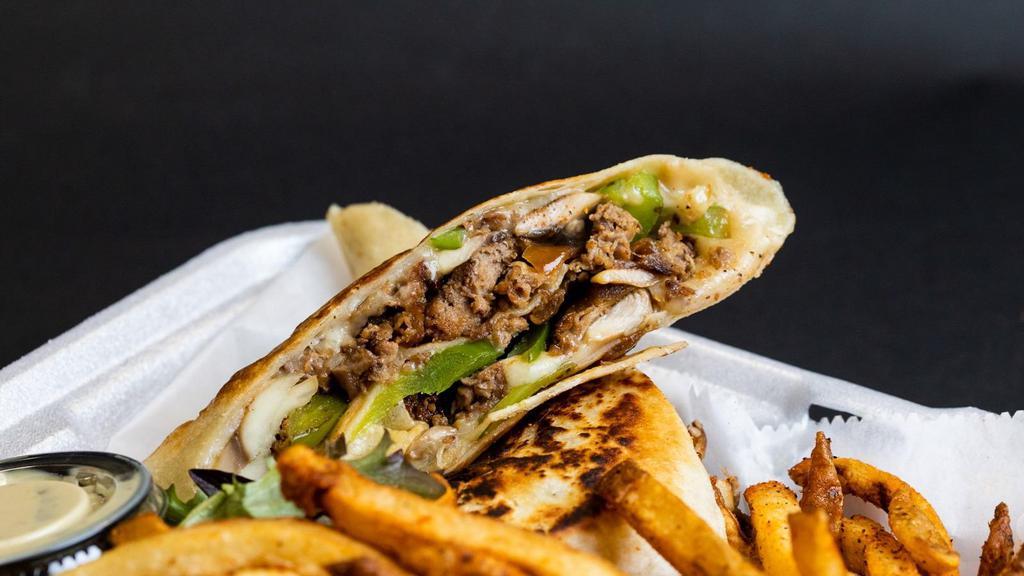 Philly Steak Wrap · Beef sirloin sautéed with our house seasoning., onions, mushrooms  green peppers, and Worcestershire sauce. Wrapped with mozzarella cheese and grilled in a flour tortilla . Mustard Aioli sauce on the side. Served with our hand-cut seasoned fries.