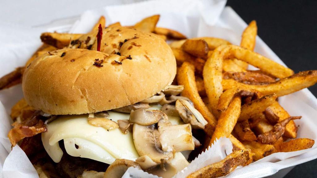 Bacon Mushroom Burger · 1/2 pound of seasoned ground beef. Topped with thick bacon, swiss cheese, grilled mushrooms and onions on a toasted brioche bun. Served with seasoned fresh hand cut fries.